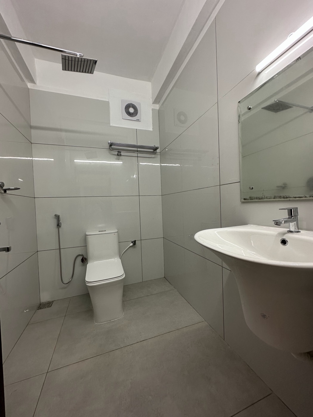 Attached bathroom with shower, toilet and wash basin