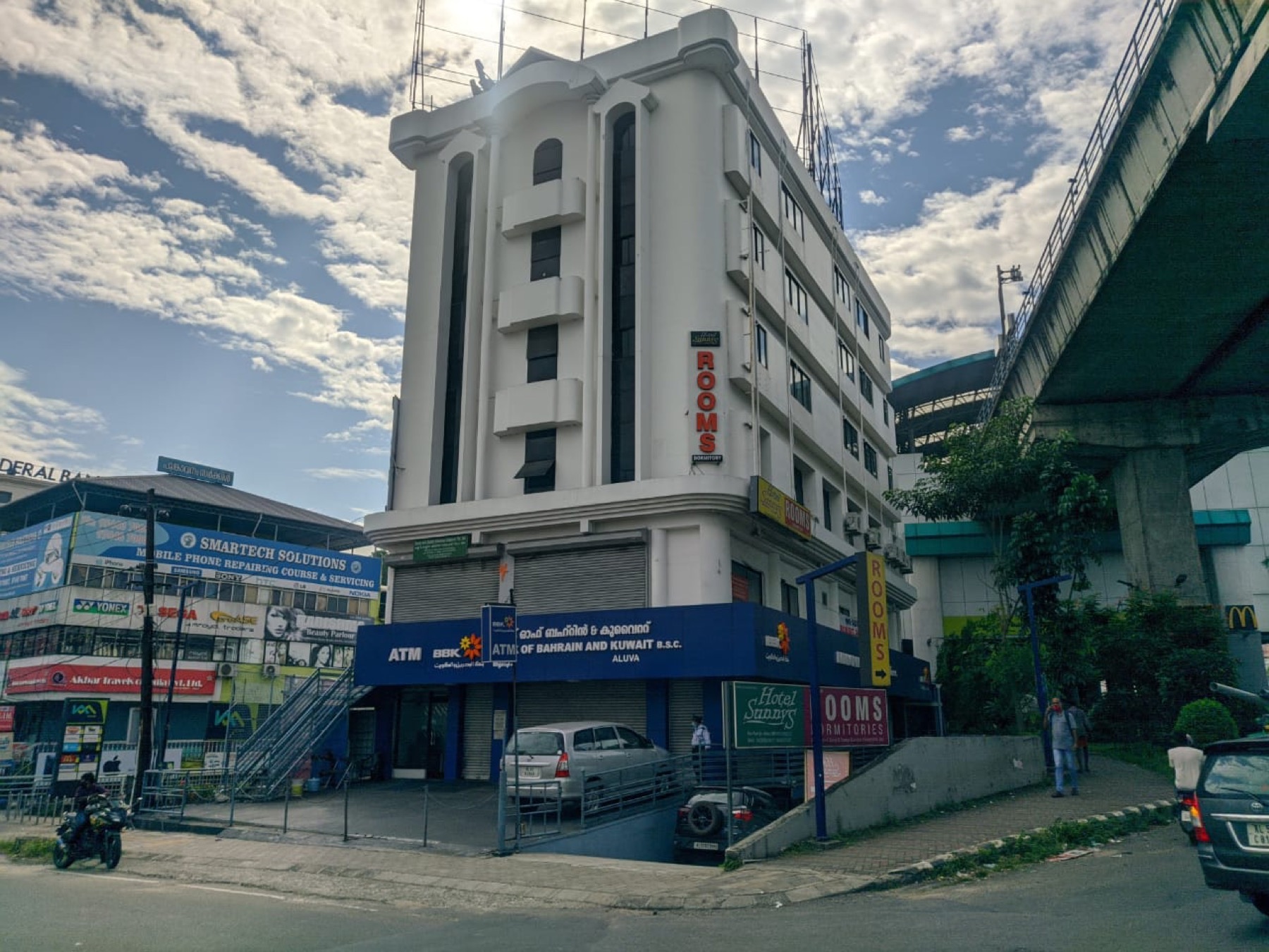 Hotel Sunnys, the white building at NH-47 Bye Pass Junction, Aluva, beside the metro